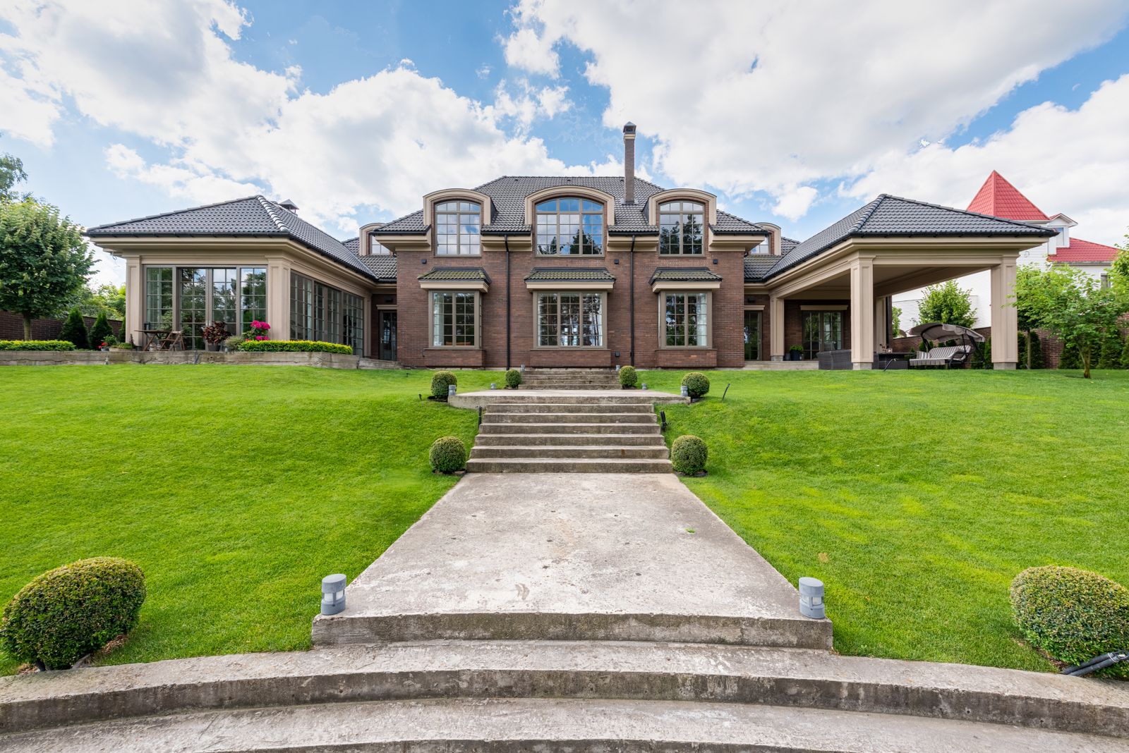 An upscale mansion behind a lush garden in Hope Ranch